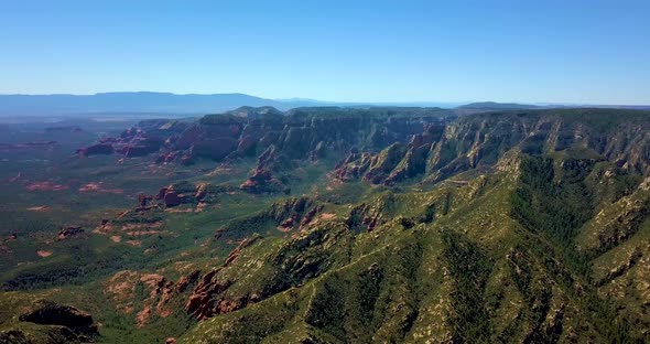 Aerial Pan of Forested Mountain Canyon, with wildfire smoke