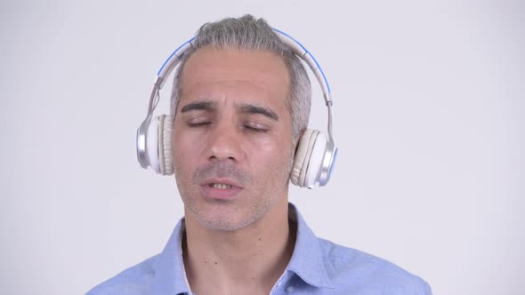 Happy Persian Businessman Listening To Music