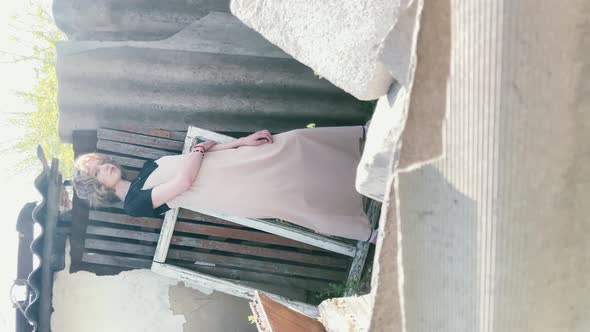 sexy girl posing at the camera in casual style. vintage street style shooting among old and discarde