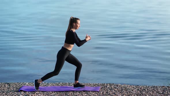 Fitness Woman Doing Lunges Exercises on Morning Training at Beach