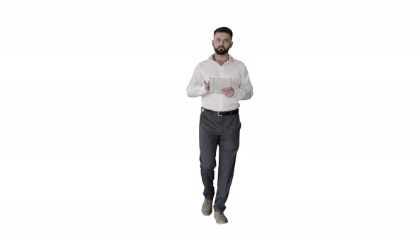 Serious Young Male Executive Using Digital Tablet and Looking to Camera Agreeing on White Background