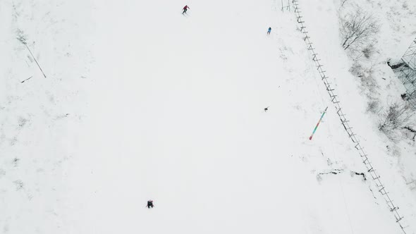 People Skiing on a Slope and Snow Tube at Ski Resort