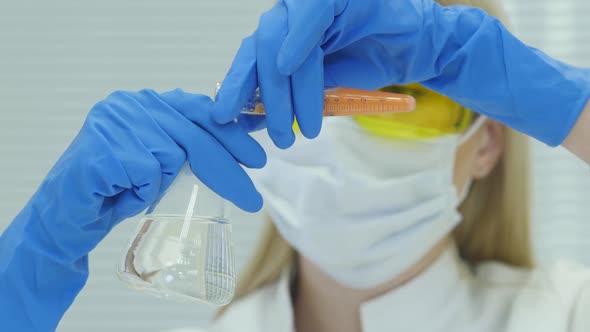 Female Pupil Conducting Chemistry Examines Coronavirus alt