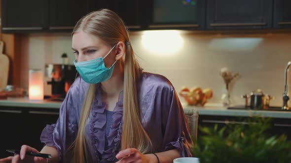 Young Business Woman in Protective Mask Working at Home on Quarantine.