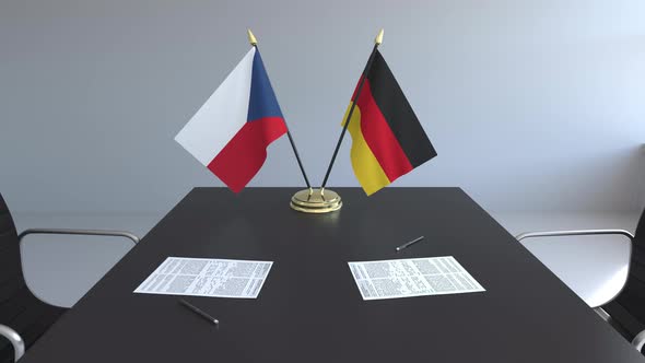 Flags of the Czech Republic and Germany and Papers on the Table
