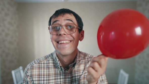 Cheerful Nerd with a Red Balloon