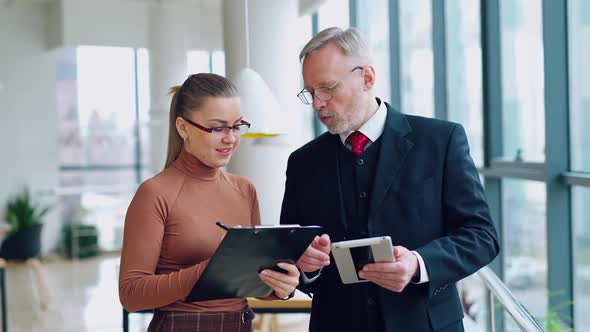 Mature businessman and female secretary.