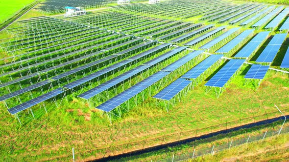 Drone fly over solar farm, renewable energy from solar.