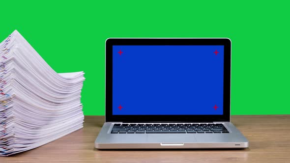 Stop motion animation Stacks overload document paper files and Blue screen laptop computer