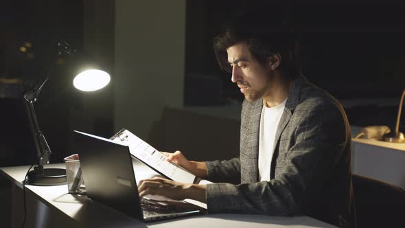 A Focused Office Worker Checks a Business Report a Man Did Not Have Time to Finish Work on Time and