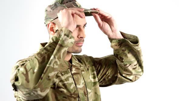 Soldier wearing patrol cap on white background