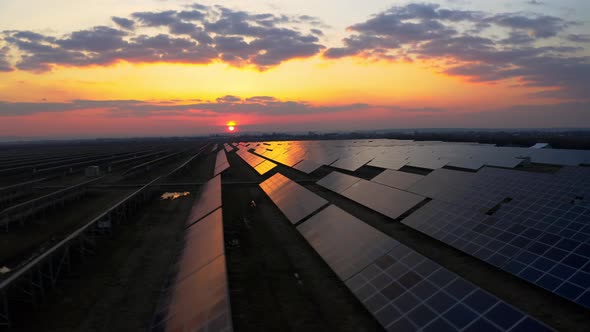 Aerial view of Solar Panel at Sunrise produces Green Energy. Ecology Concept