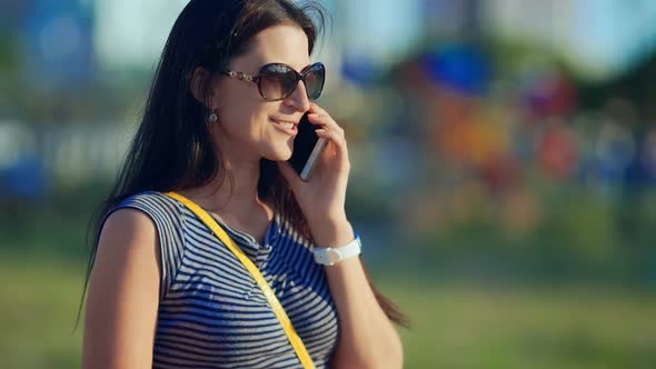 Young Beautiful Smiling Woman Talking on Cell Phone