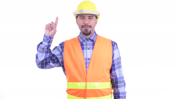 Happy Bearded Persian Man Construction Worker Pointing Up