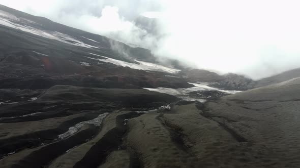 the top of the black volcano in the clouds