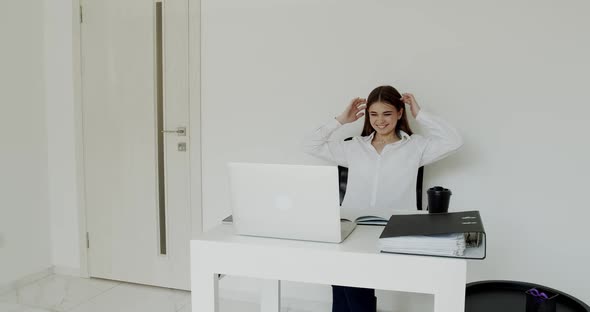 Happy Office Girl Rejoices at the Laptop at Workplace Raises Hands and Laughs