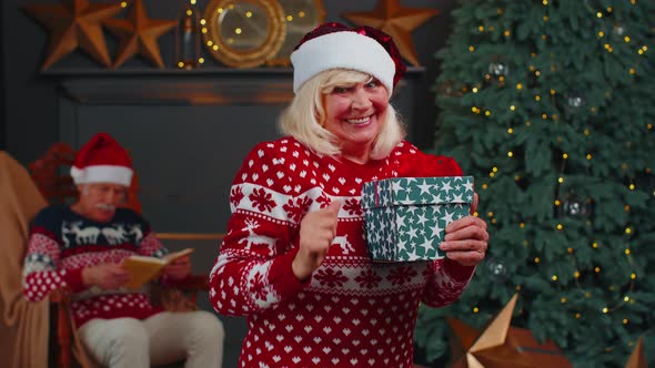 Senior Grandmother in Christmas Sweater Celebrate Success Win Scream Doing Winner Hands Gesture