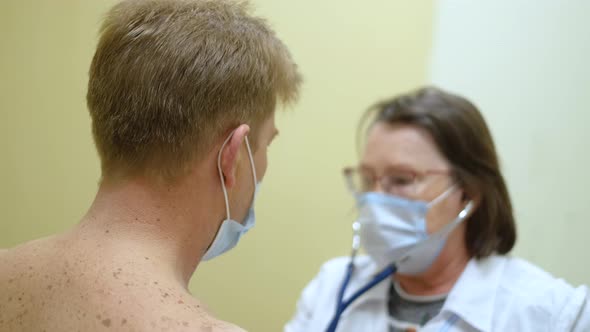 Male Patient Lungs are Listened with Stethoscope Device By Specialist Doctor