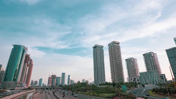 View on modern skyscrapers and busy evening highways day to night transition