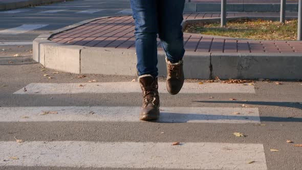 A Woman in Brown Shoes Crosses the Road at a Pedestrian Crossing Legs Closeup