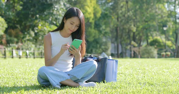 Student use of cellphone on green lawn