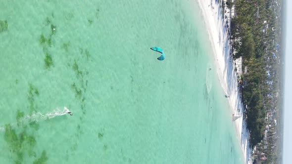 Vertical Video Kitesurfing Near the Shore of Zanzibar Tanzania Aerial View