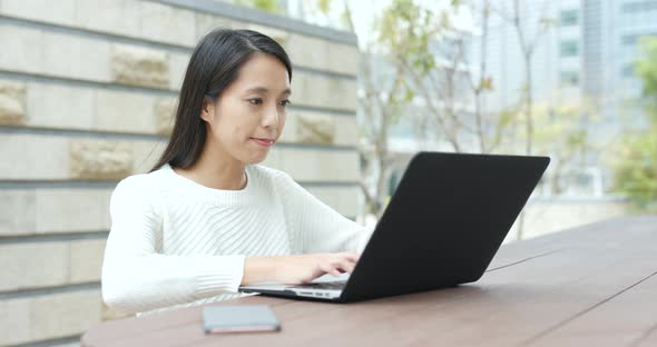 Woman use of notebook computer at outdoor