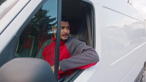 Young Indian Man Showing Thumb Up Through the Window of the Van