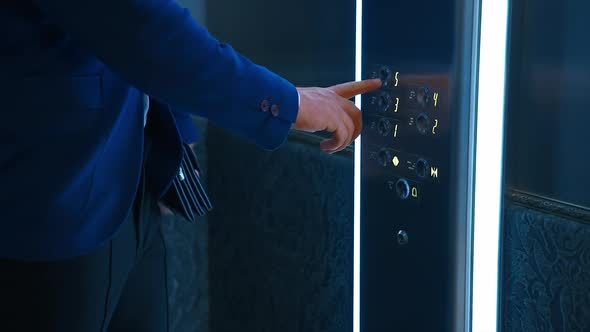 Man pressing elevator button. Traveling businessman with suitcase waiting for elevator in hotel