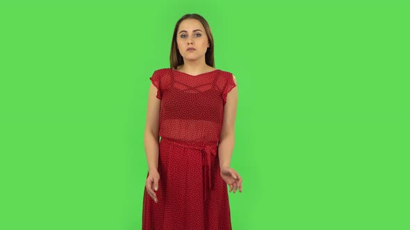 Tender Upset Girl in Red Dress Is Shrugging and Sighing. Green Screen