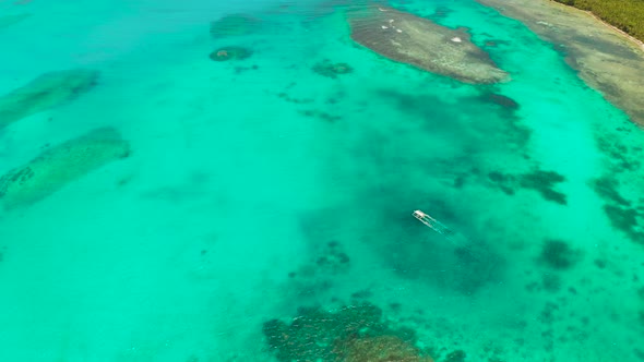 Seascape, Coral Reef and Blue Sea with Motorboat