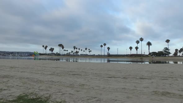 Tracking shot of a man jogging on the bay and beach