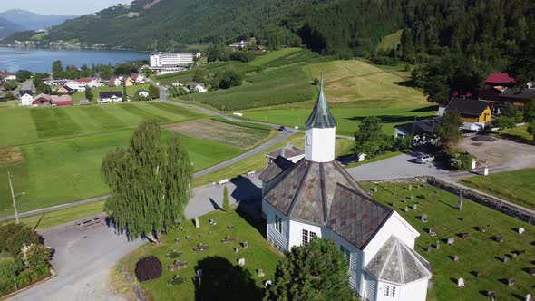 Loen church - Beautiful rotating and bacward moving aerial - Seeing church surrounded by green field