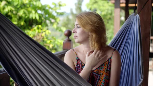 Attractive Young Woman Rrelaxing in a Hammock