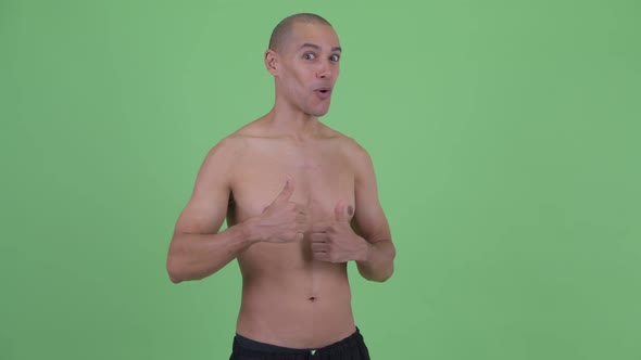 Happy Bald Multi Ethnic Shirtless Man Giving Thumbs Up and Looking Excited