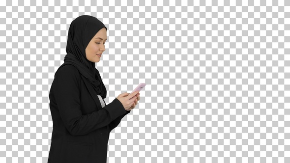 Muslim woman messaging on her mobile phone, Alpha Channel