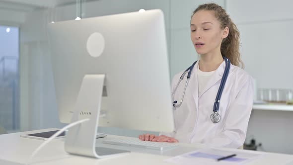 Portrait of Young Female Doctor Doing Video Chat on Desk Top