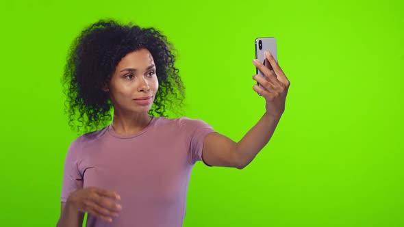 African Woman Takes Selfie on Modern Smartphone Has Happy Expression