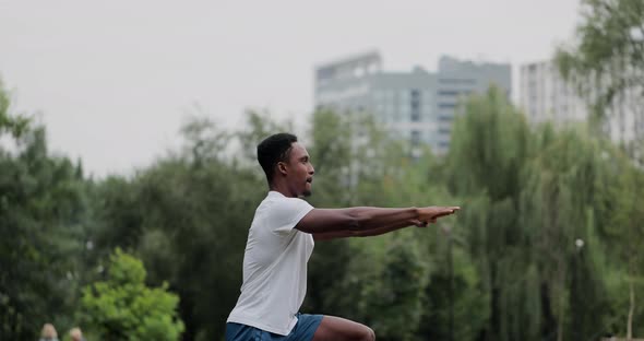 African American Man Limberingup and Stretching Legs After Running Jog Workout