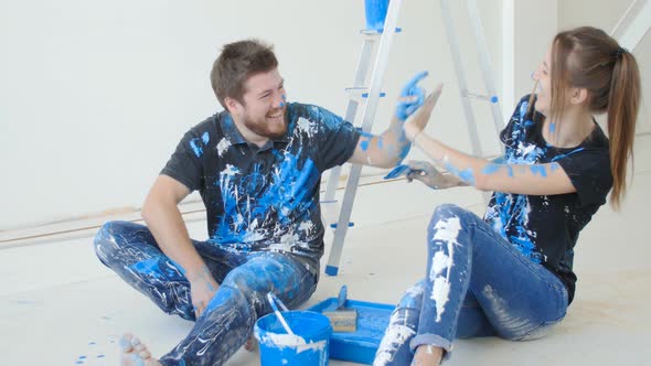 Happy Charming Couple Having Fun and Painting a Room in Their New House