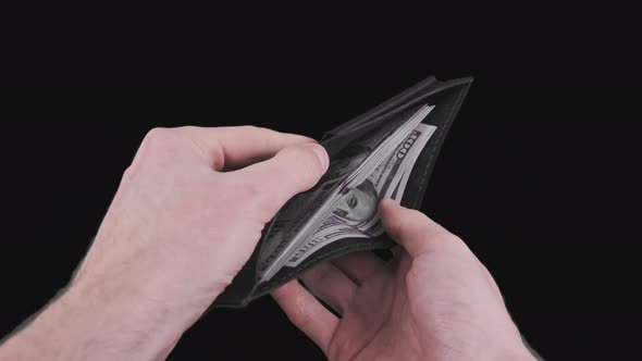 Male Hands Show a Black Wallet with 100 Dollar Bills on Alpha Channel
