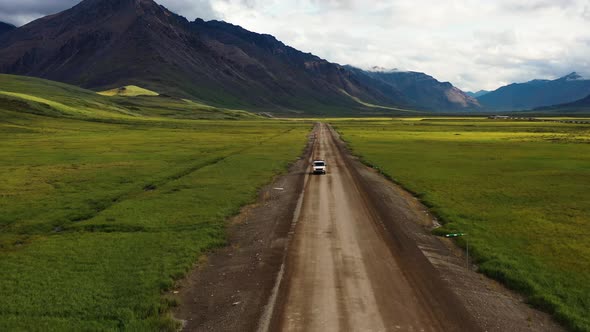 Road trip on a van through Portage valley by the Brooks Range mountains in Summer Alaska - Aerial tr