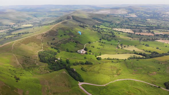 Amazing aerial video of paragliding over green area. Hipster modern hobby concept.