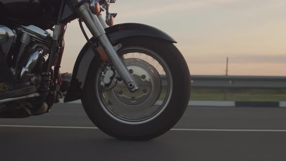 Closeup of Front Wheel Motorbike Driving on Highway Side View