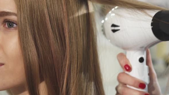 Cropped Close Up of a Gorgeous Young Woman Getting Her Hair Styled at the Salon