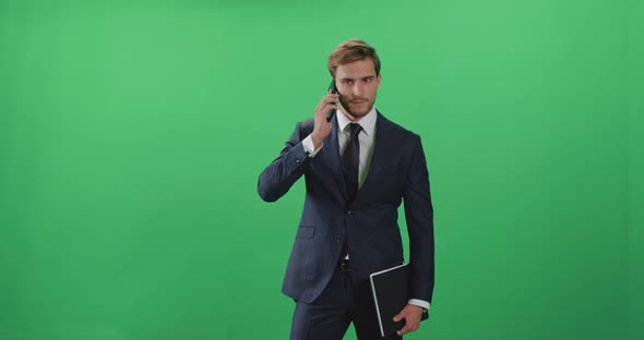 Businessman in a Suit Standing and Talking on a Mobile Phone, Top Manager 