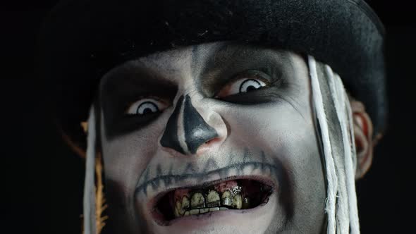 Man with Skeleton Makeup Trying To Scare, Opening His Mouth and Showing Dirty Black Teeth and Tongue