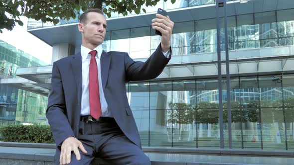 Businessman Taking Selfie on Phone