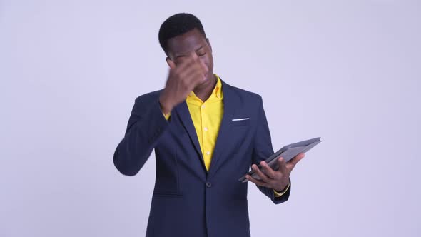 Young Stressed African Businessman Using Digital Tablet and Getting Bad News