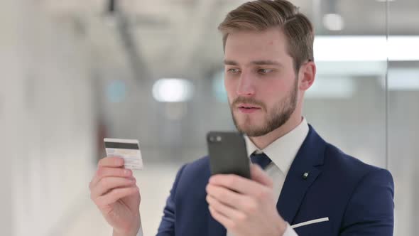 Young Businessman Having Unsuccessful Online Payment on Smartphone